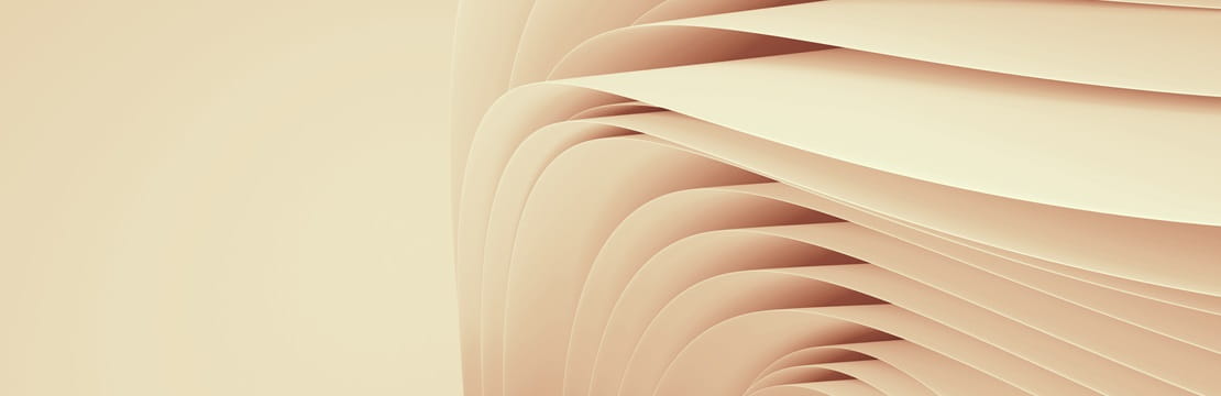 The image shows a series of smooth, curved, beige layers or folds that create an abstract, flowing pattern.